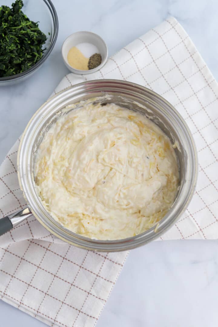 melting the cream cheese and shredded cheese in a saucepan.