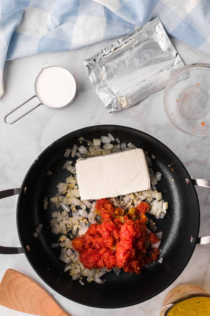 cooking the onions, cream cheese and Rotel.