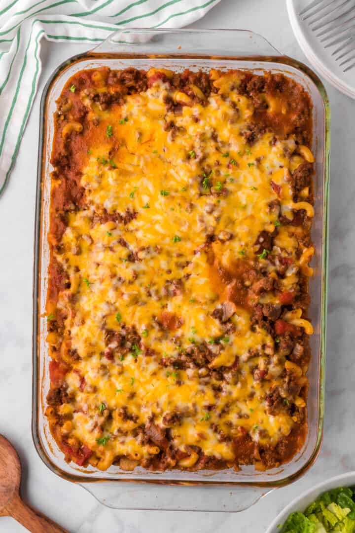 Chili Mac Casserole in casserole dish topped with cheese.