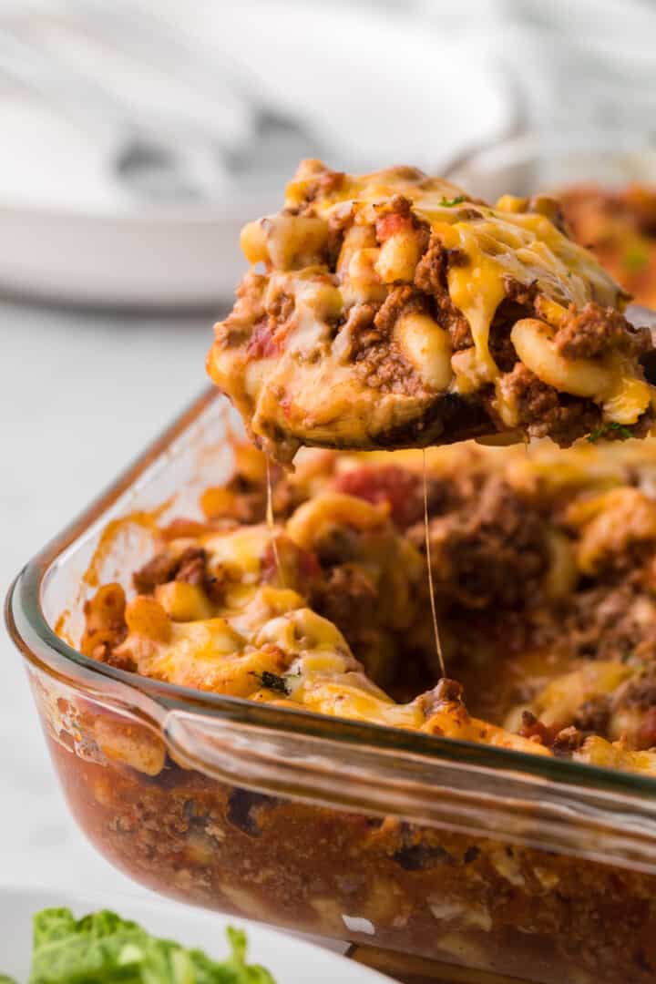 Chili Mac Casserole being served out of casserole dish.