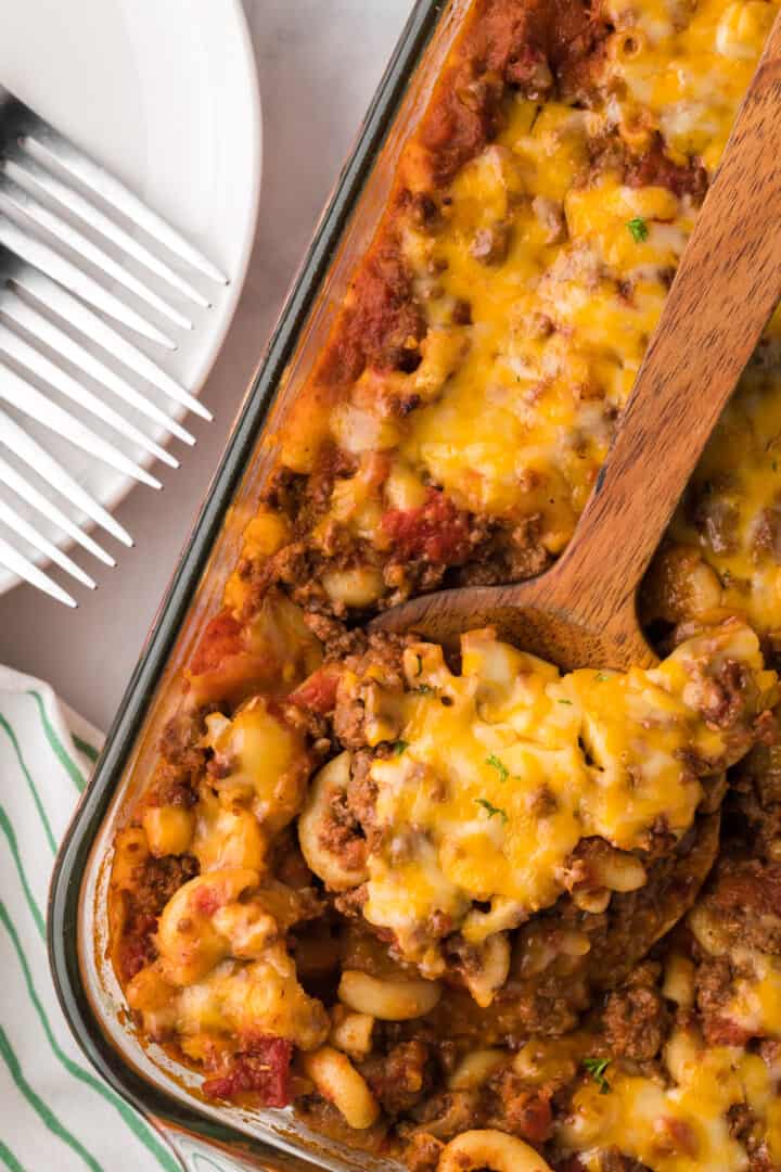 serving Chili Mac with wooden spoon.