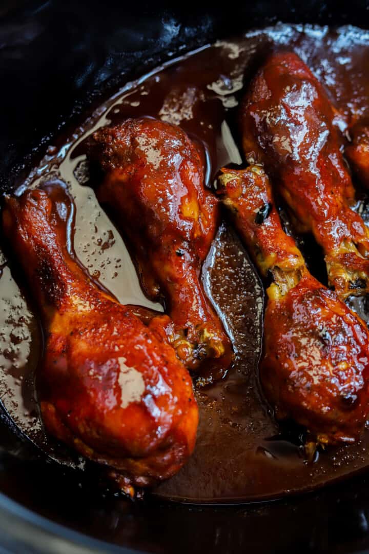 Slow Cooker BBQ Chicken Legs closeup in the slow cooker.