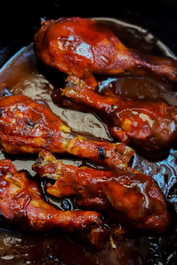 cooked BBQ chicken legs in slow cooker.