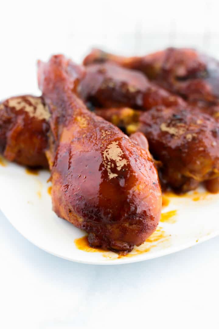 BBQ Chicken legs on white plate.