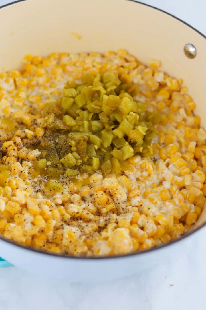 adding the green chilies to the corn, and melting it all together.