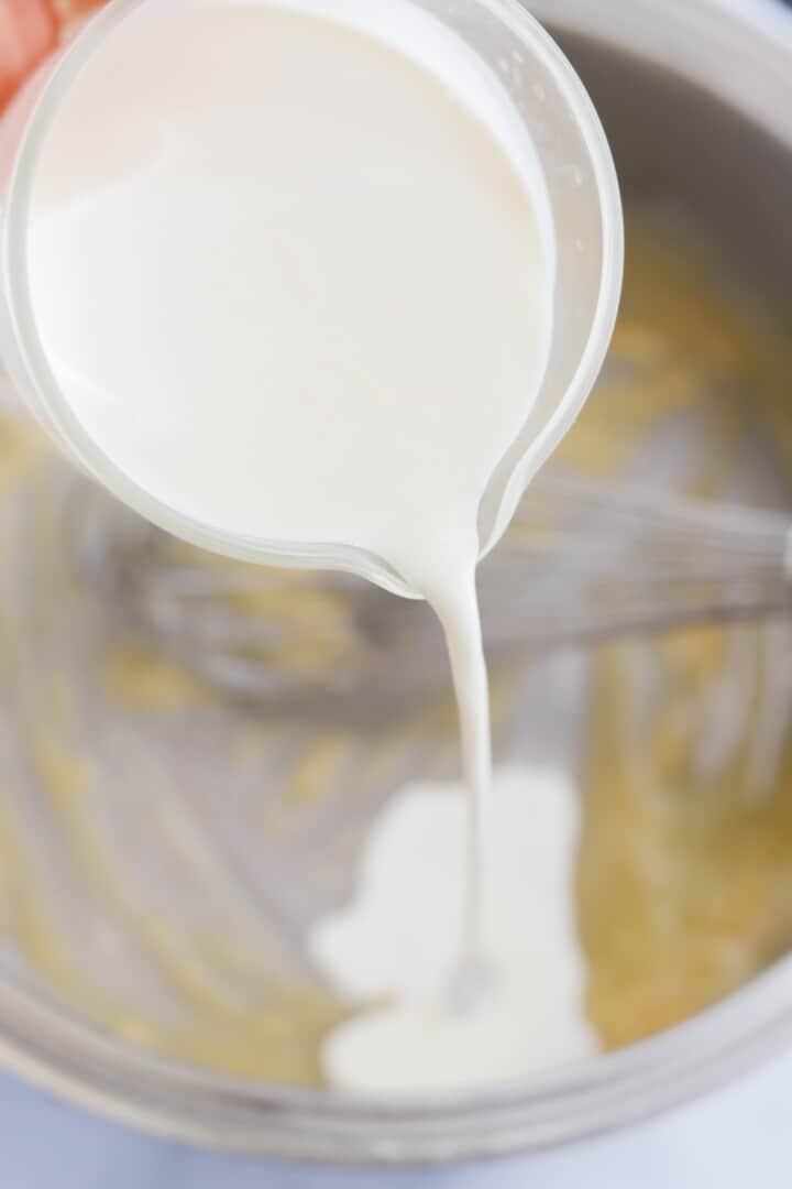 pouring the half and half into the pan with the butter.