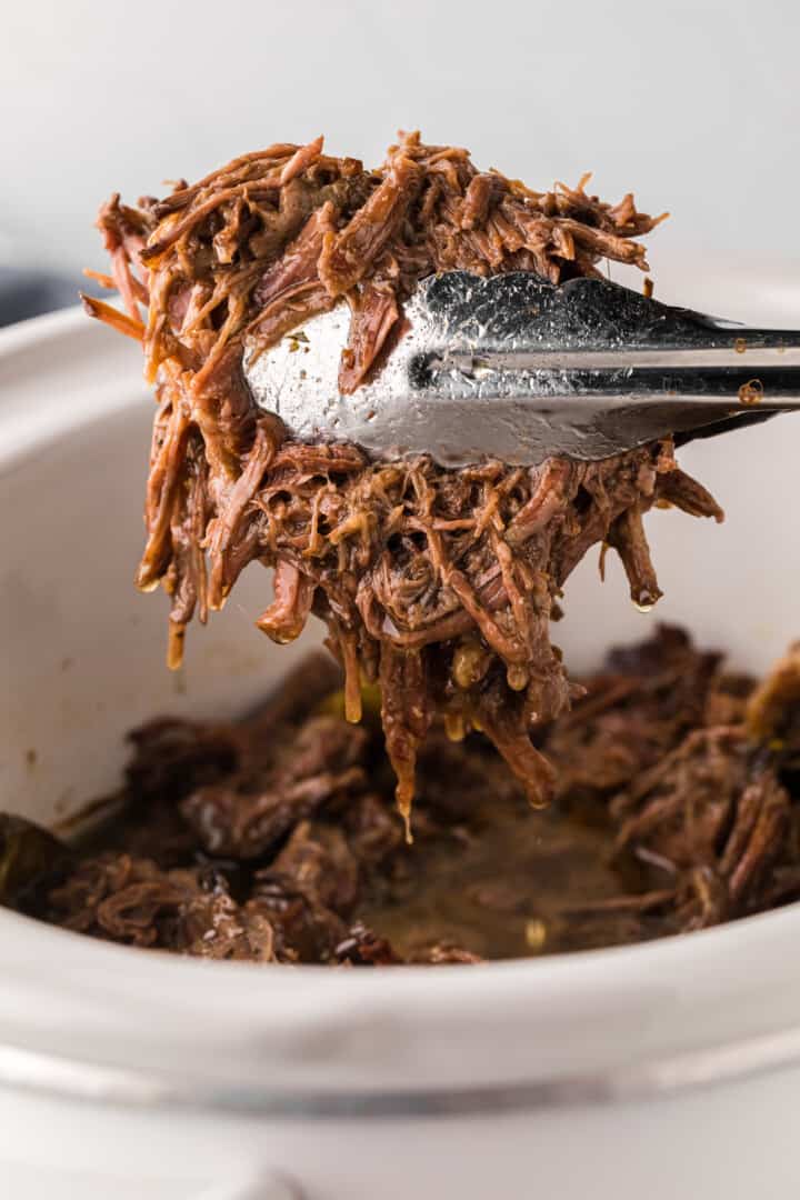 use tongs to serve the pot roast out of the slow cooker.