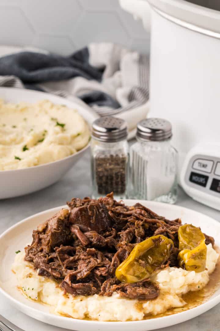 Mississippi Pot Roast on top of mashed potatoes.