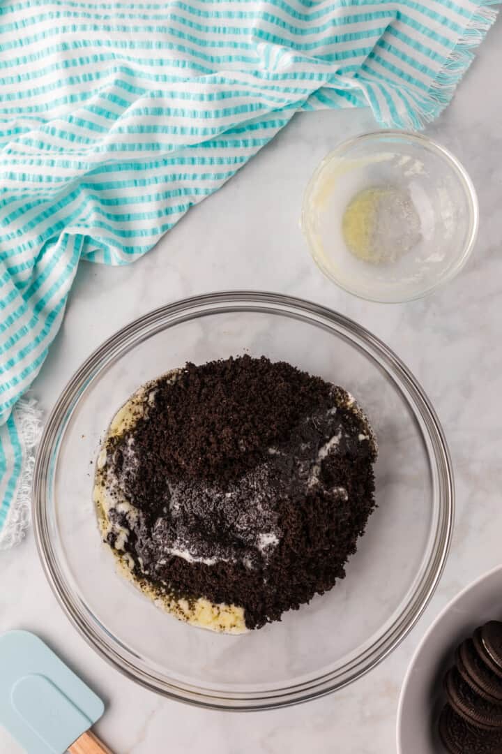 crushed Oreos and melted butter to make the pie crust.