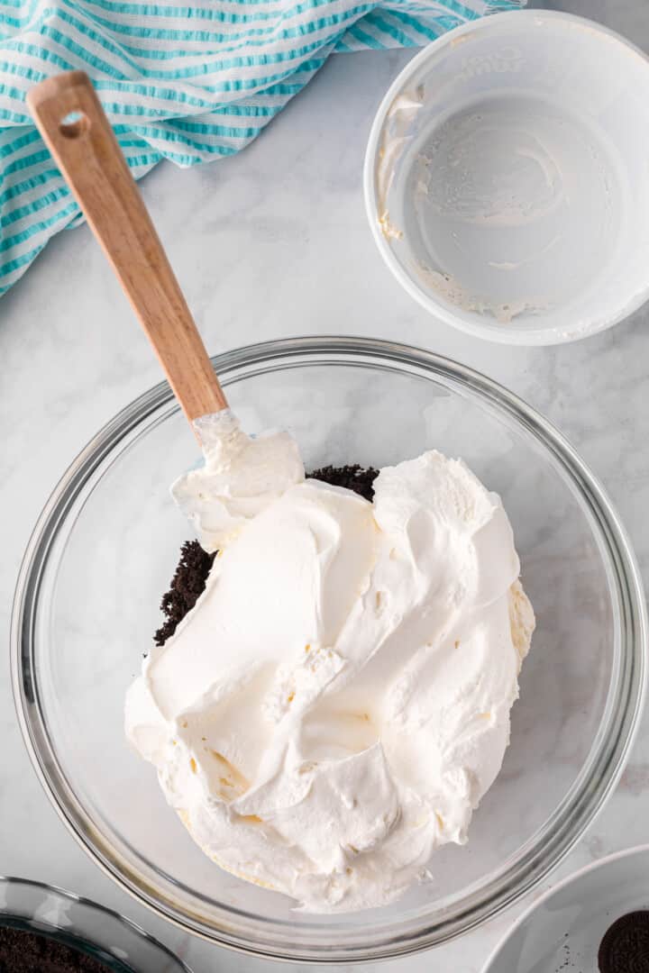 mixing the whipped cream with crushed Oreos for the filling.