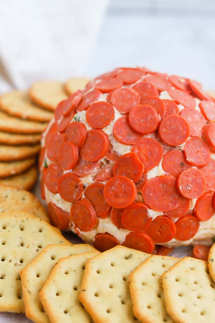 closeup of pepperoni cheeseball with crackers.