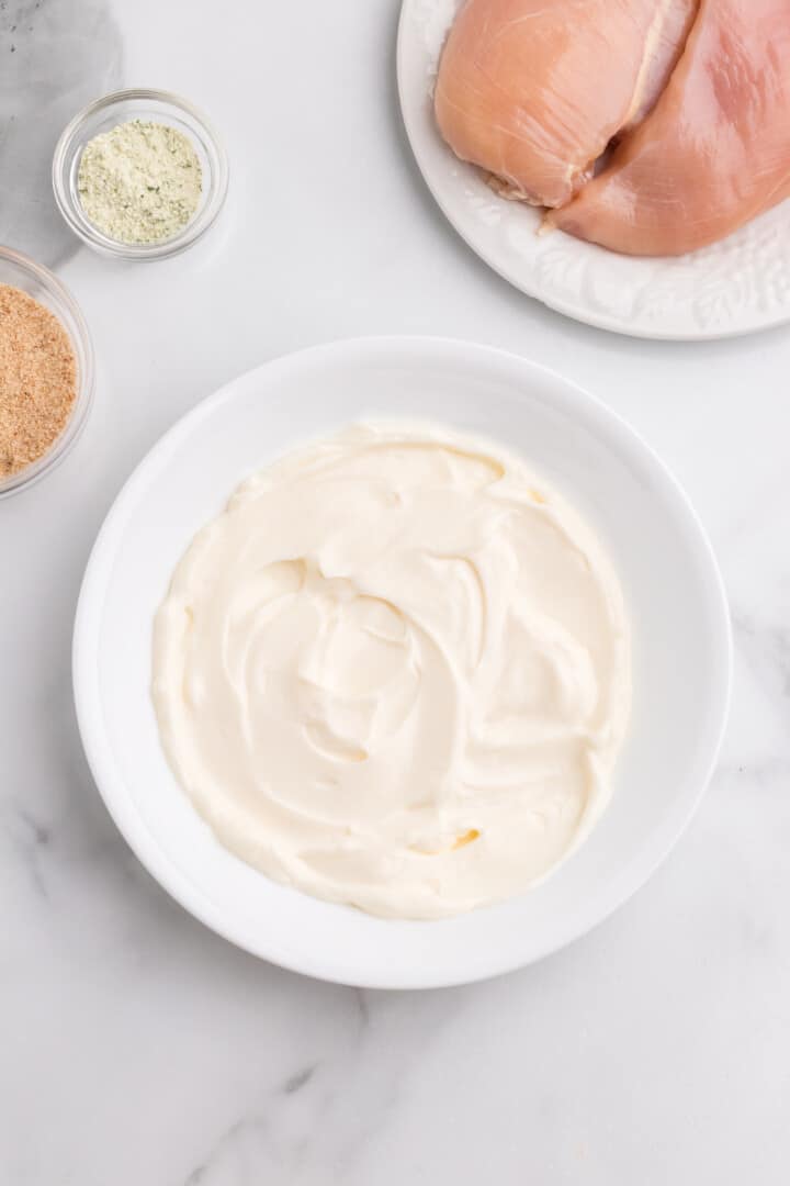 mayonnaise in white bowl for dredging the chicken.