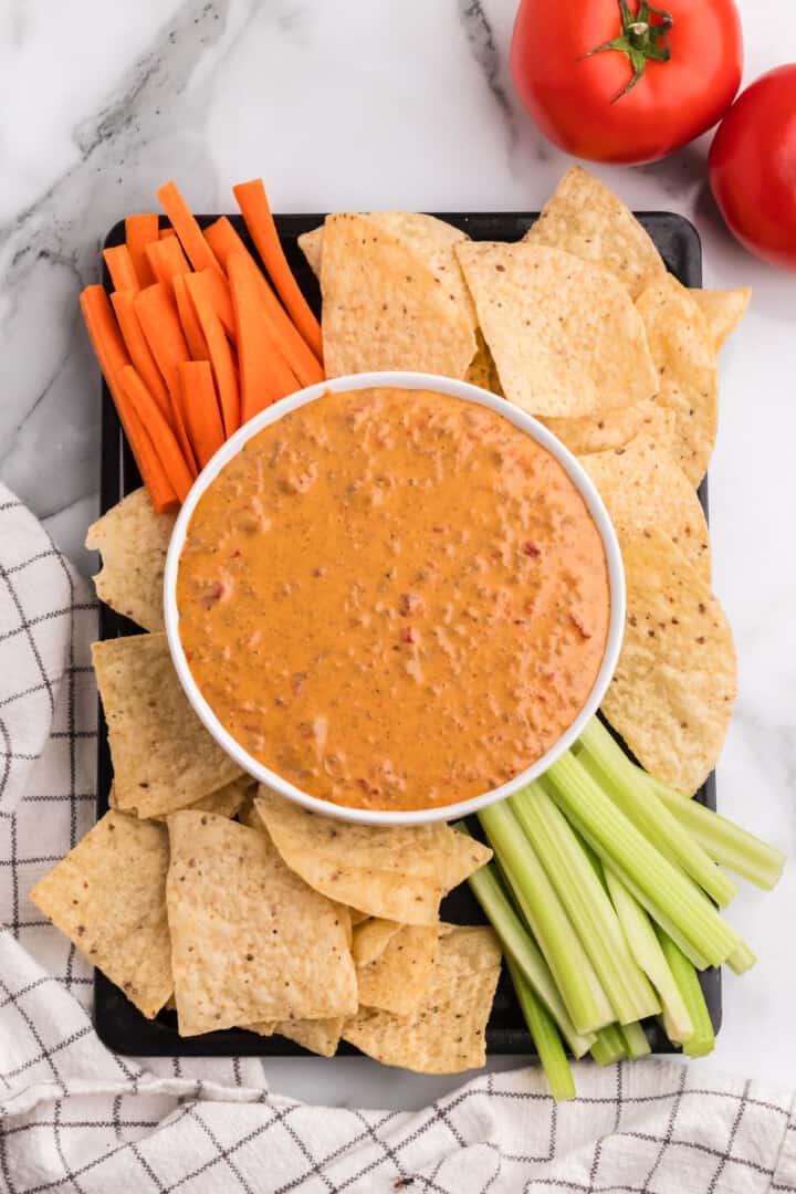 Rotel Dip on serving tray with chips and veggies.