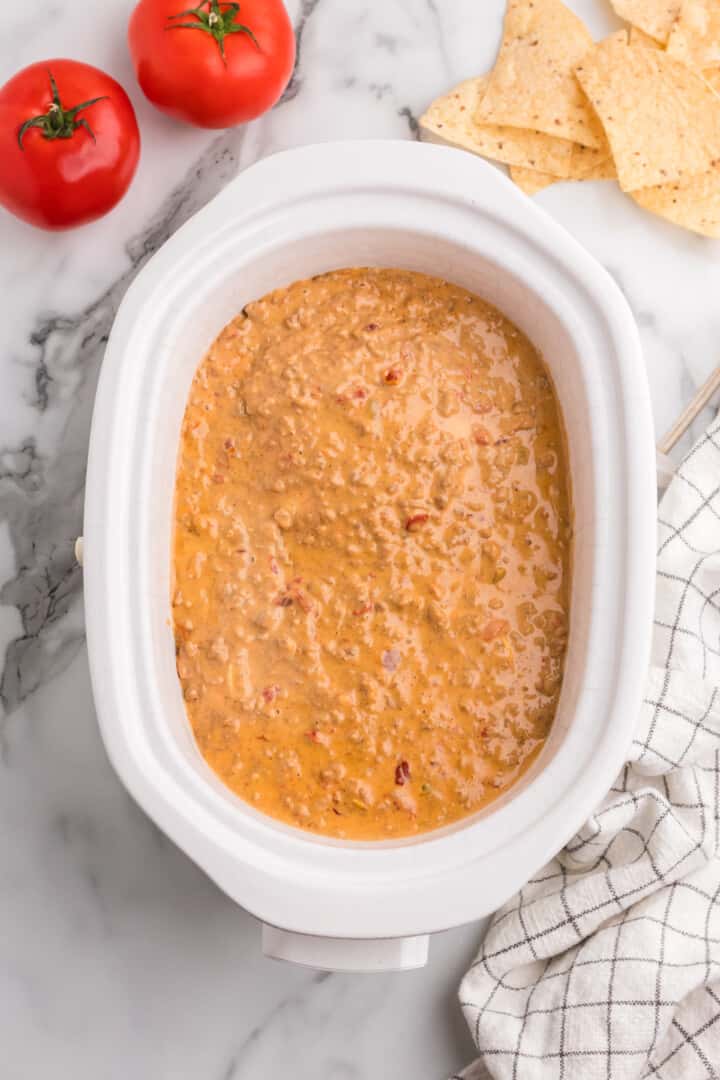Rotel Dip in slow cooker heating up.