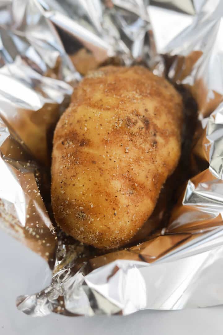 seasoned potato wrapped in tin foil for cooking.