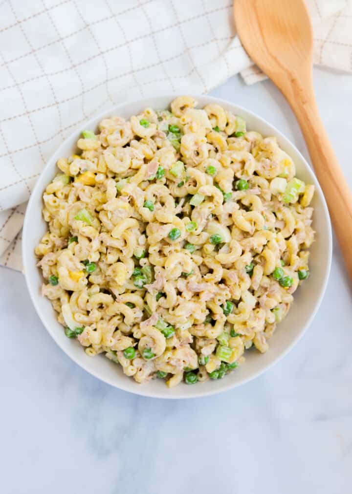 top view of tuna macaroni salad in white serving bowl.