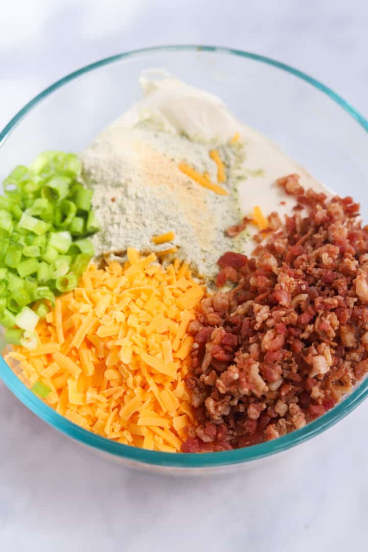 ingredients for the cheeseball in a glass mixing bowl.