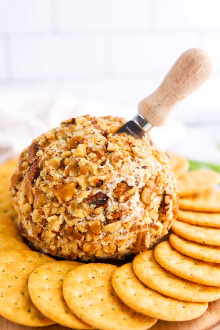 Bacon Ranch Cheese Ball with serving knife in it.