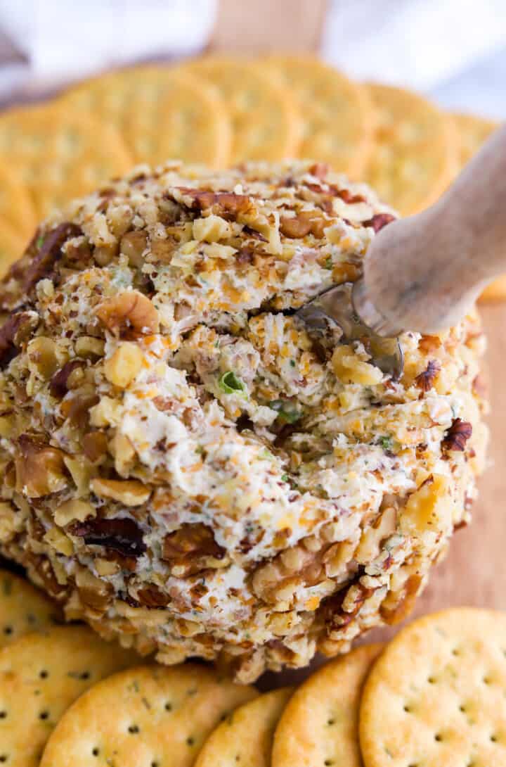 closeup of cheeseball with knife in it.