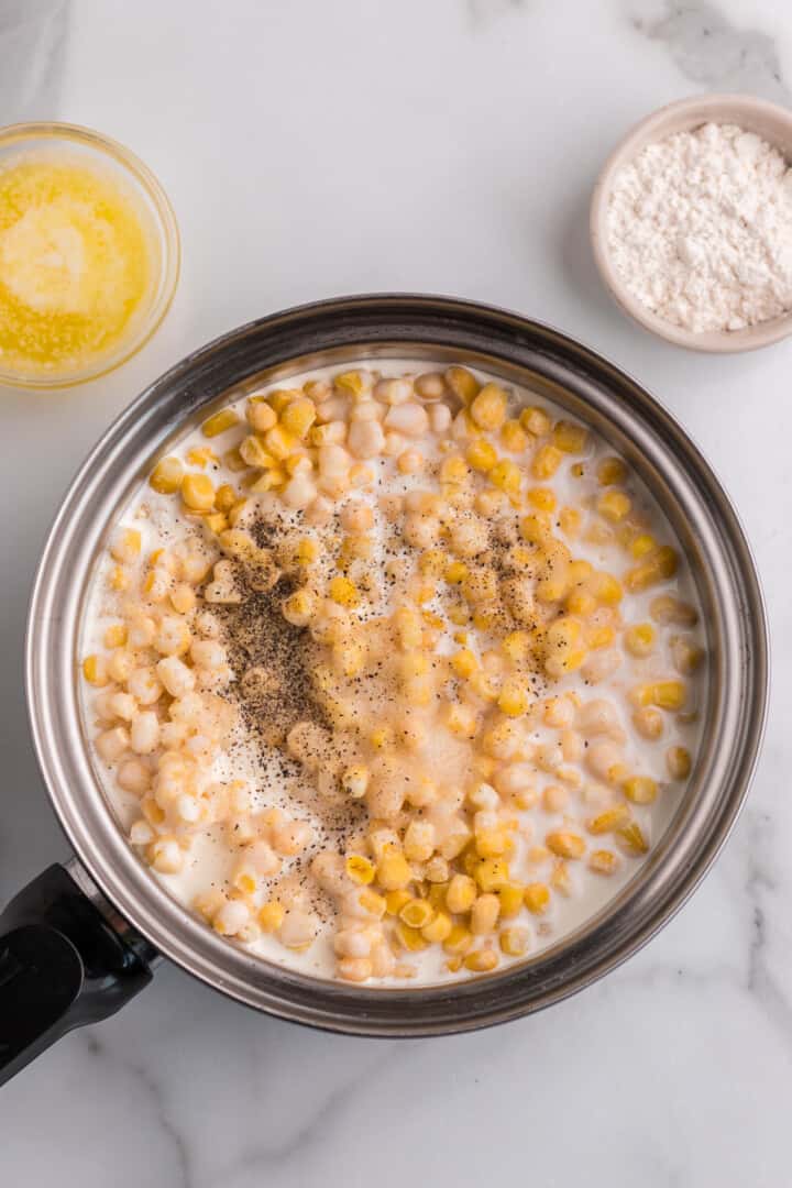 cooking the creamed corn in a pan.