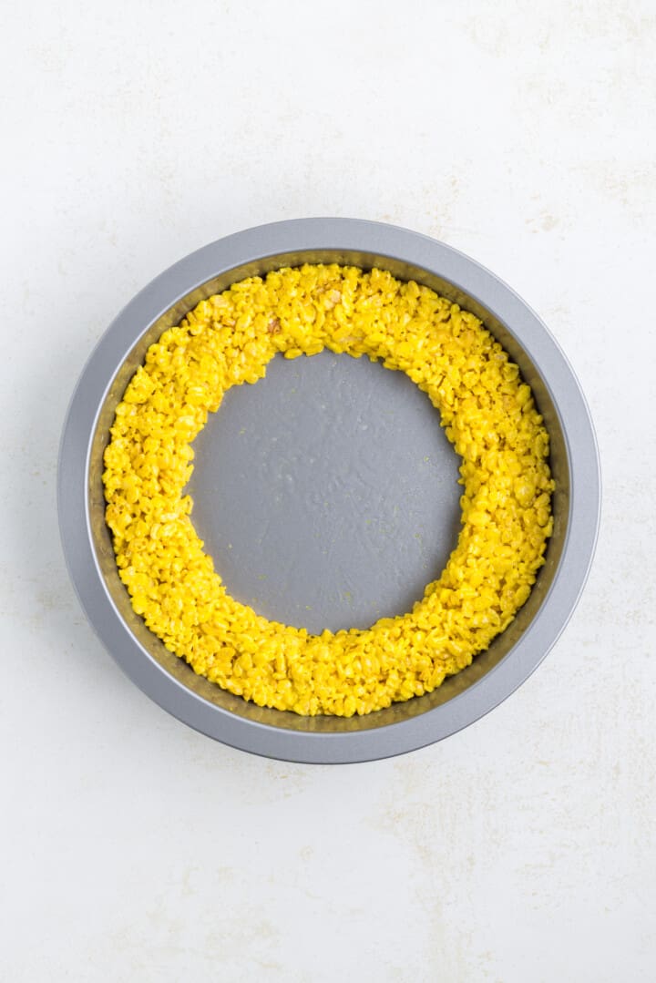 yellow rice Krispies pressed into round baking dish.
