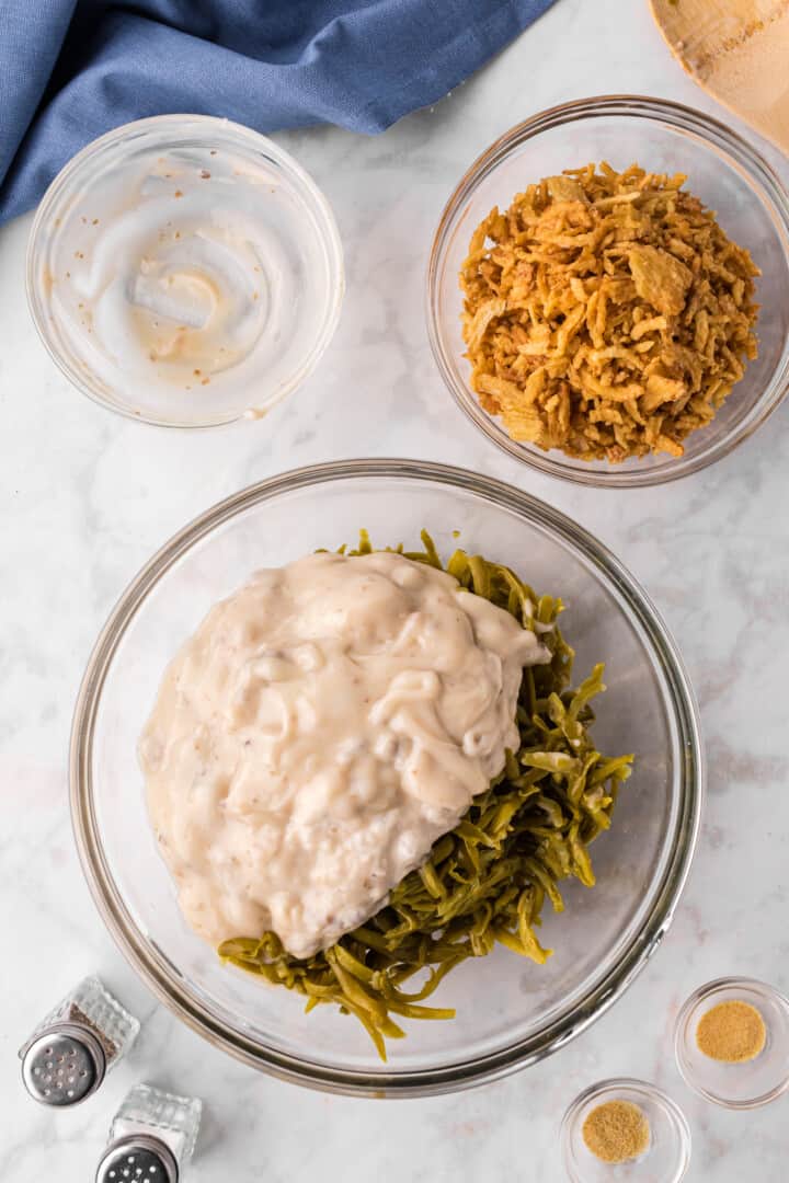 mixing the green beans with the cream of mushroom soup.