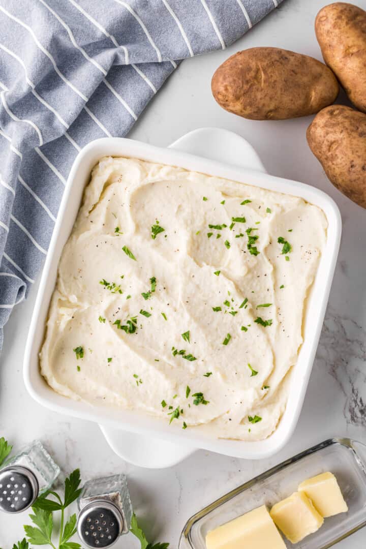 mashed potatoes in a white casserole dish.