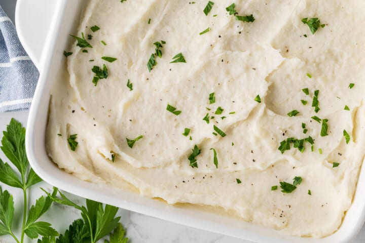 closeup of mashed potatoes topped with chives.