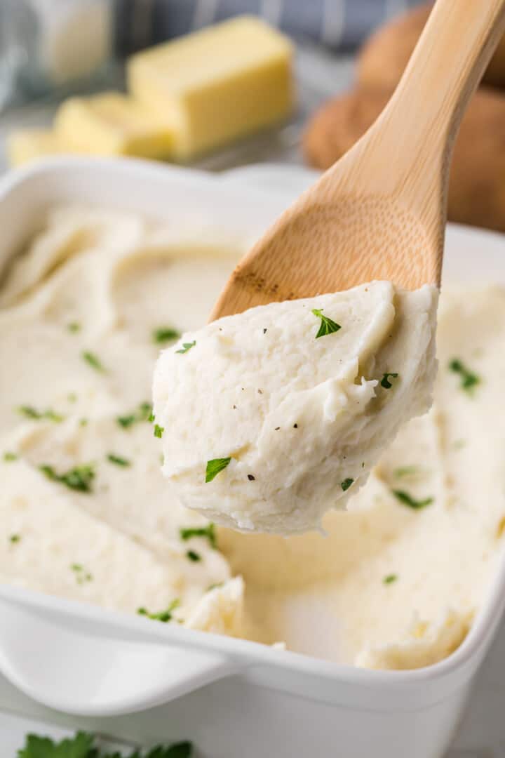 serving the mashed potatoes out of the casserole dish with a wooden spoon.