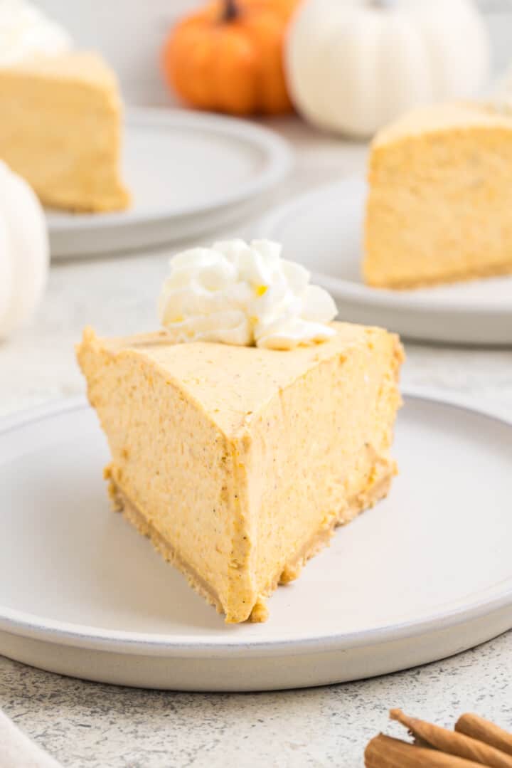 Slice of No Bake Pumpkin Pie on white plate.