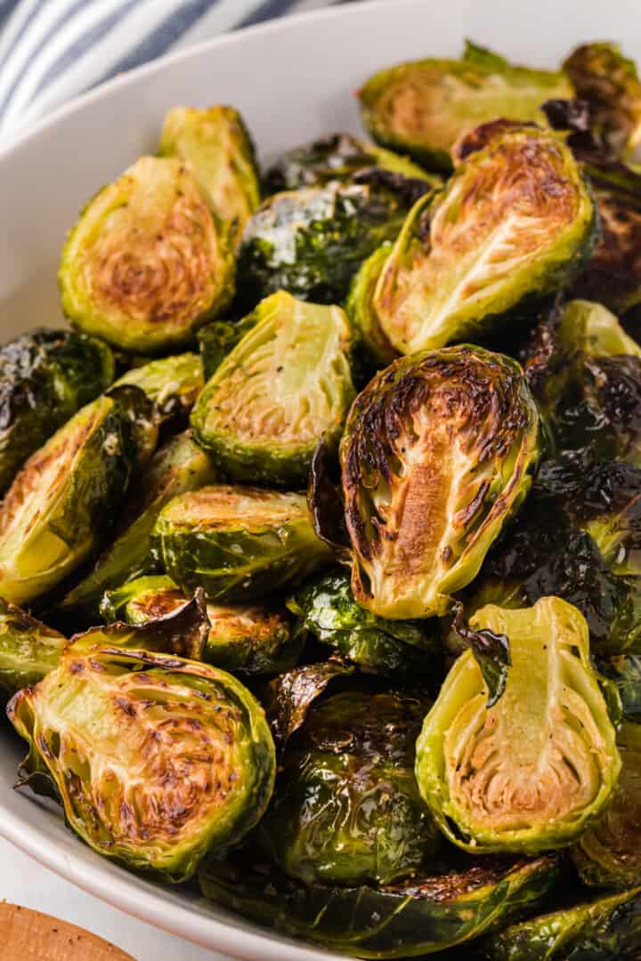 closeup of Brussel Sprouts in white serving bowl.