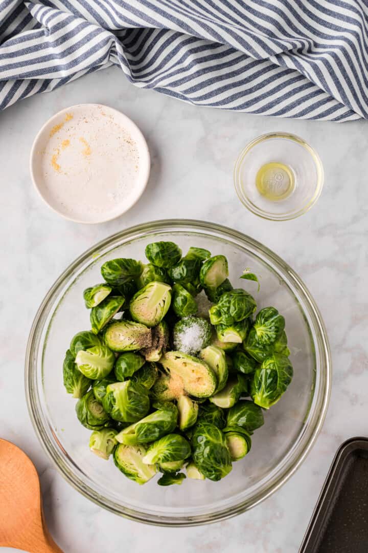 Seasoning the Brussel Sprouts.