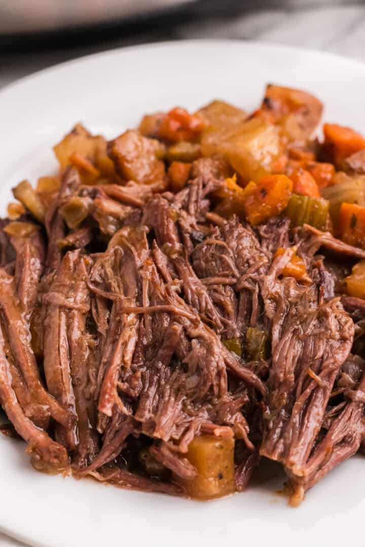 Slow Cooker Pot Roast with veggies on white plate.