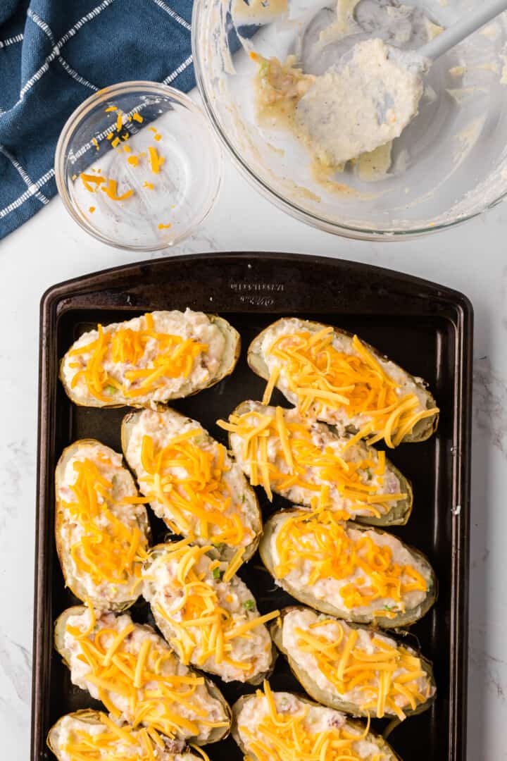Twice Baked Potatoes filled and topped with cheese before baking a second time.