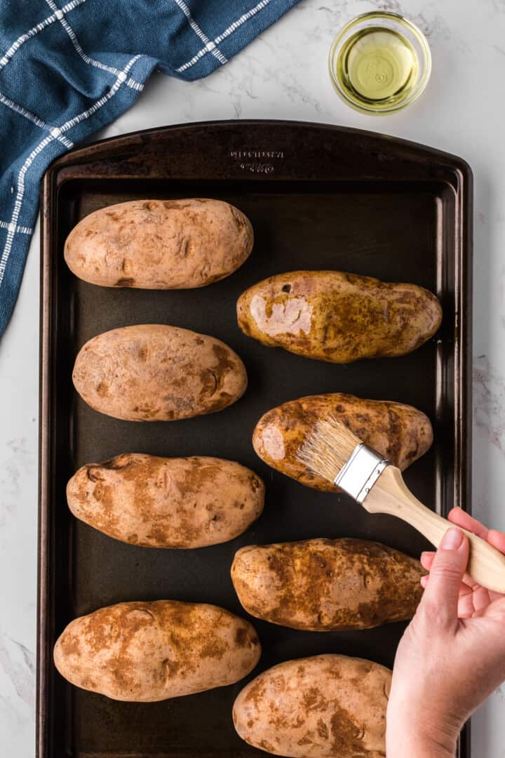 brushing oil on the potatoes before baking.