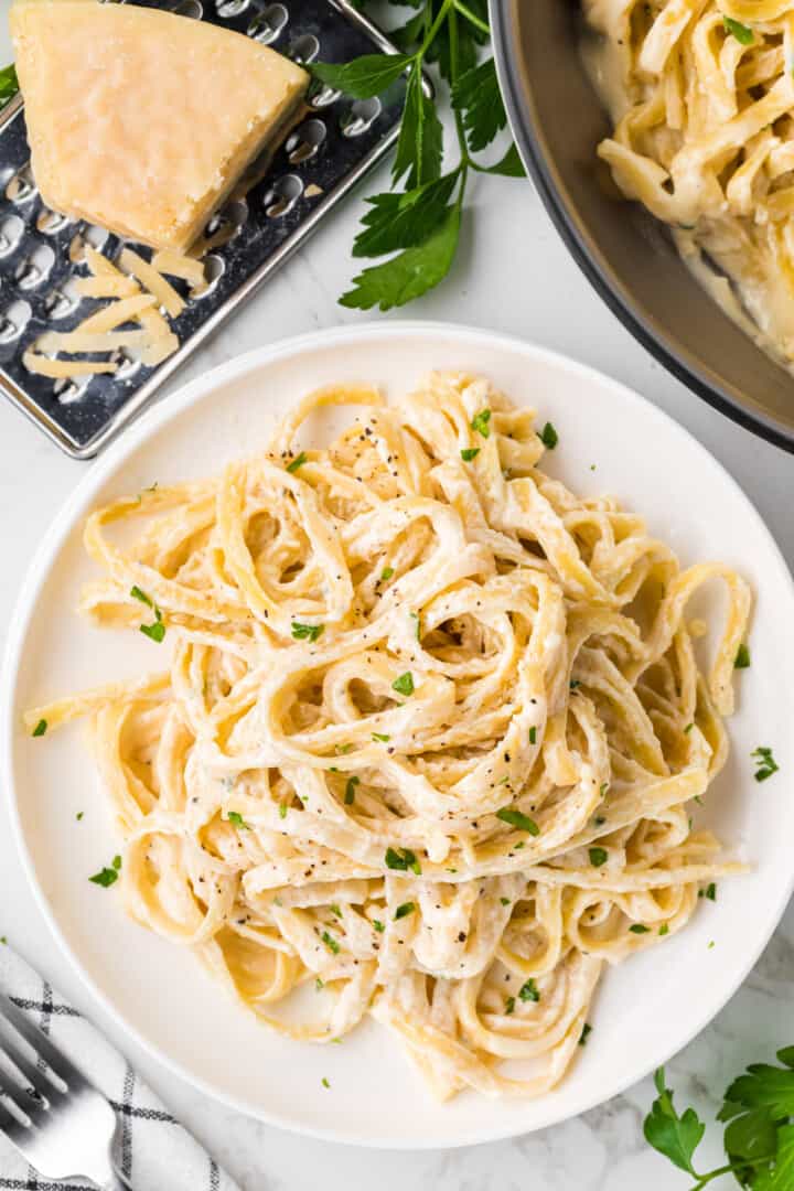 a top-down view of a plate of fettuccini alfredo.