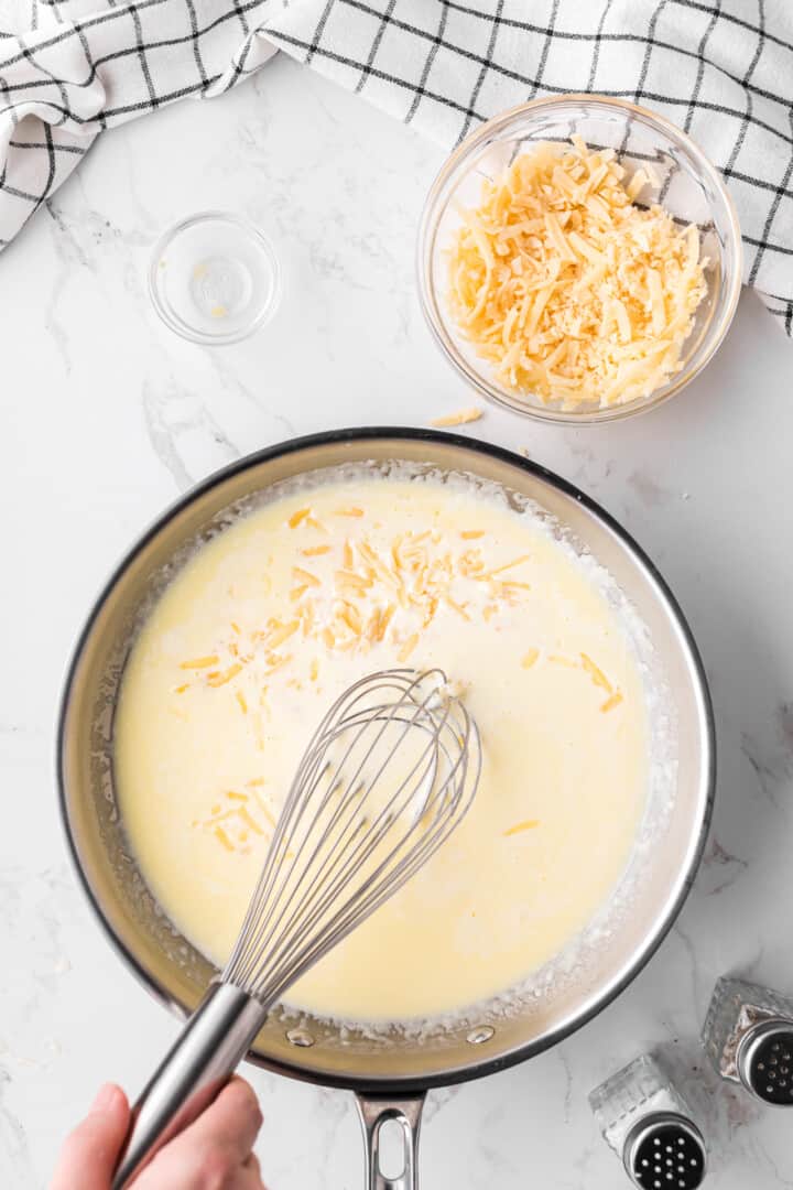 whisking in the parmesan cheese for the sauce.