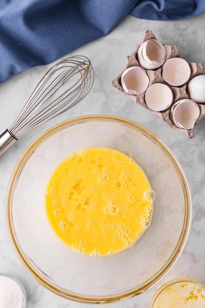 whisked eggs in glass bowl.