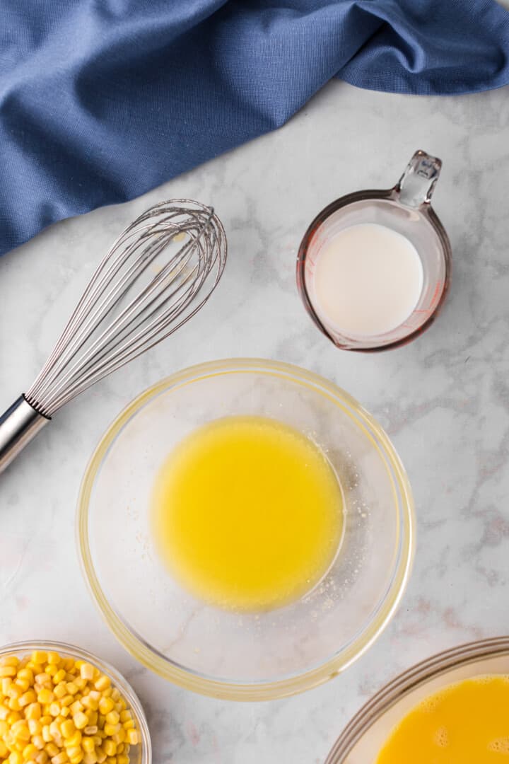 mixing butter and sugar together in glass bowl.