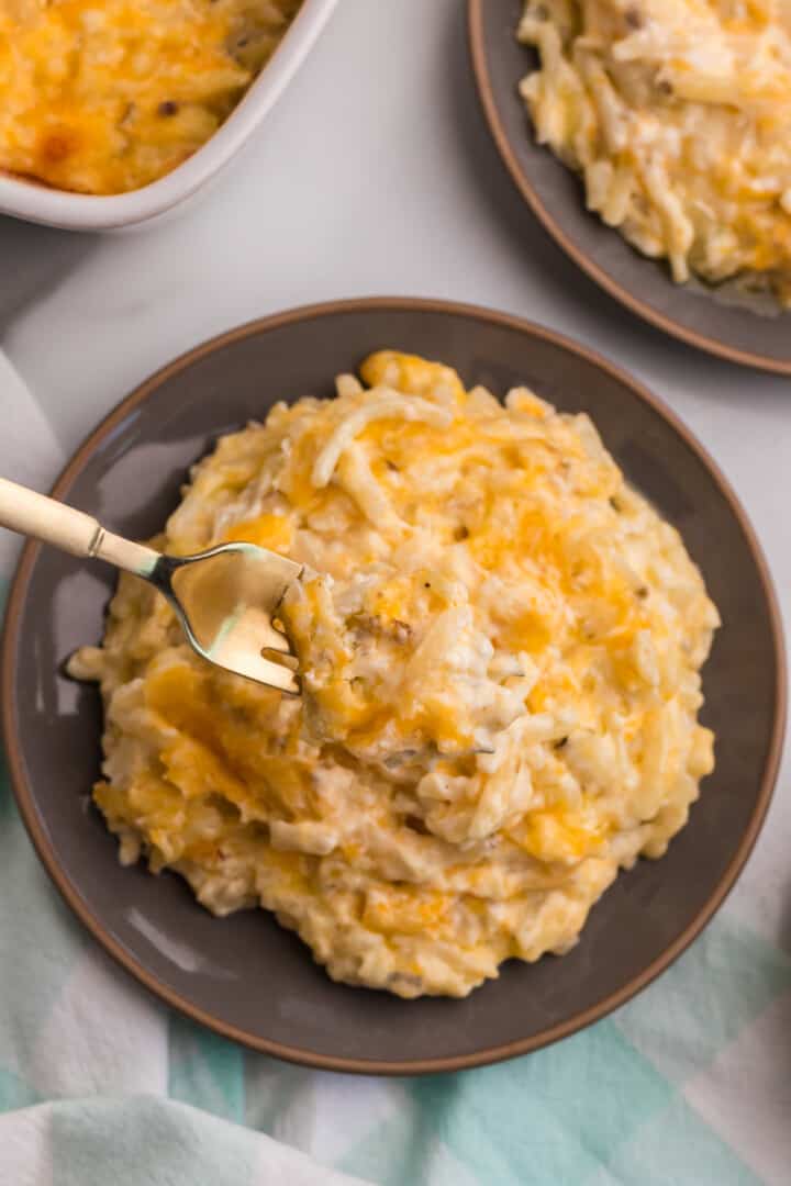 using a fork to eat the hashbrown casserole.
