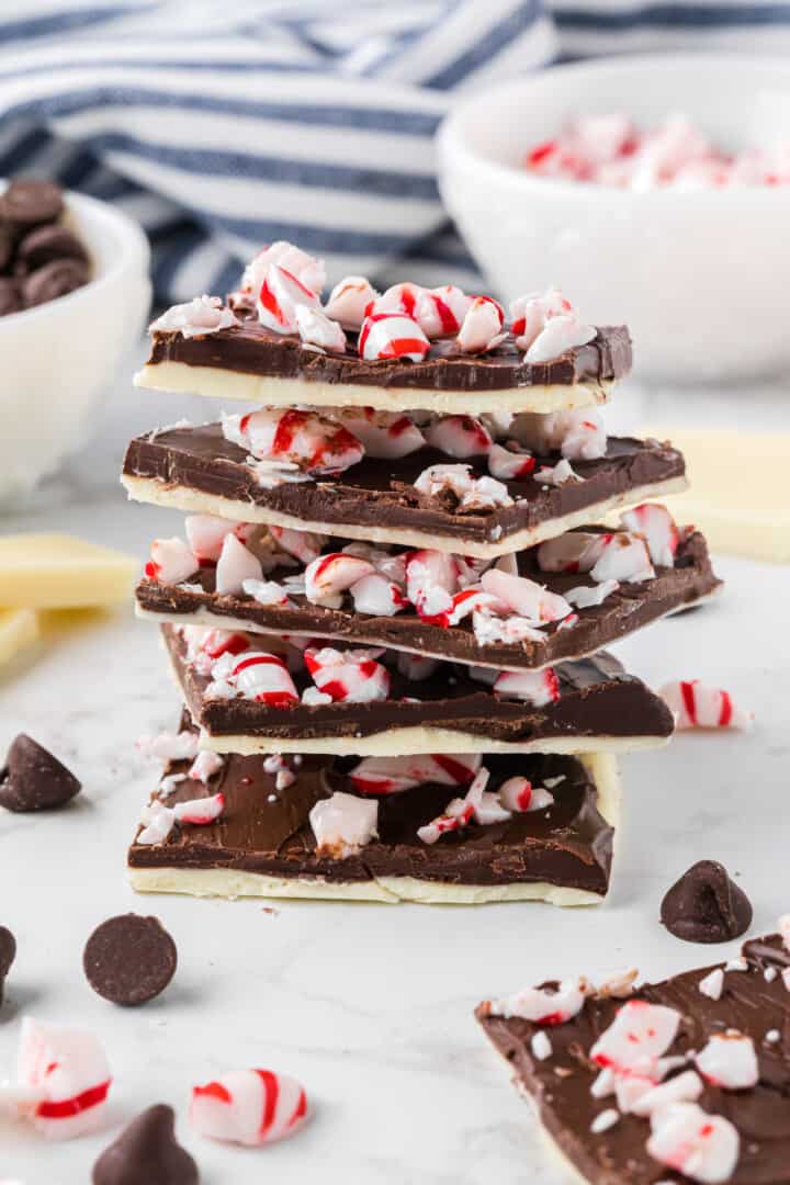 five pieces of peppermint bark stacked on top of each other.