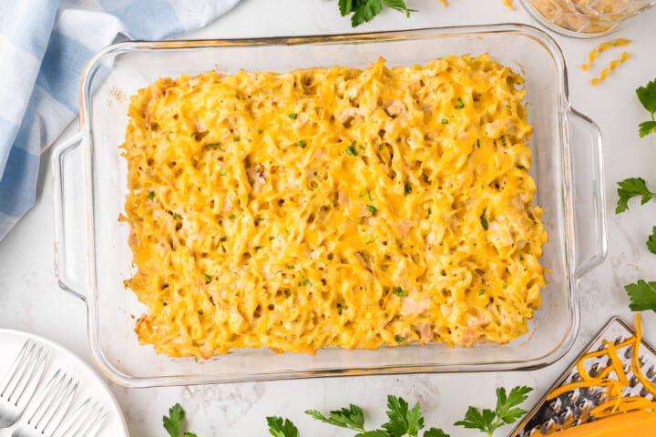 baked tuna casserole in a clear casserole dish.