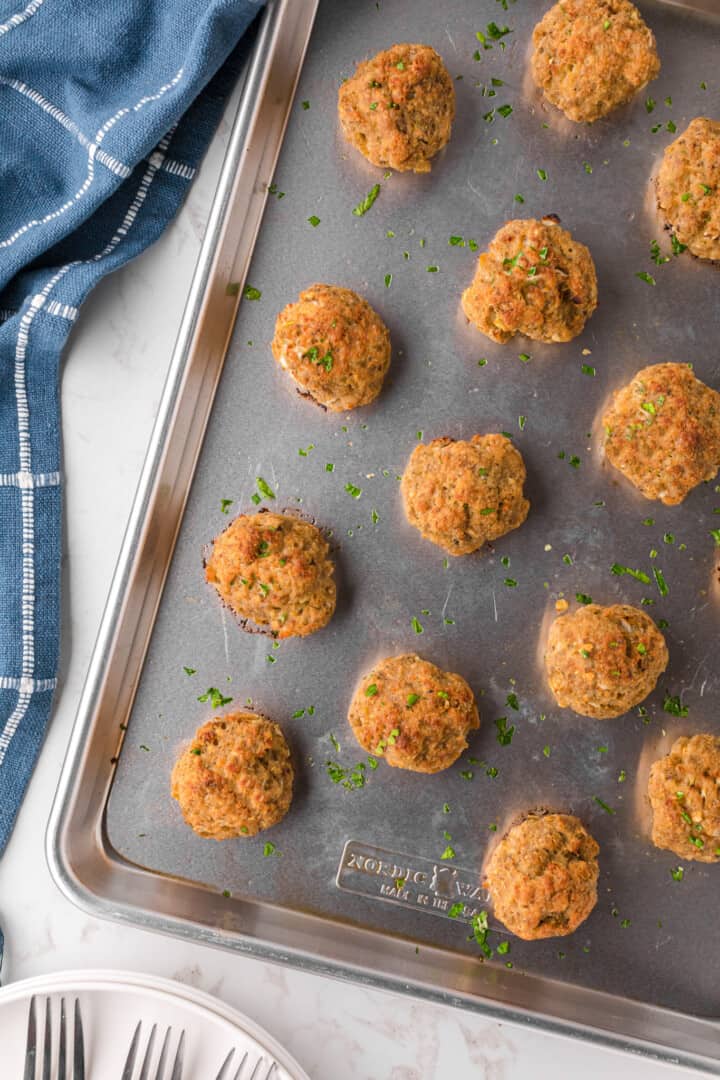 baked turkey meatballs on baking sheet.