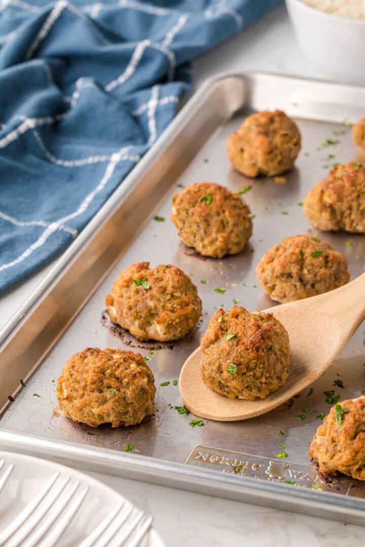 closeup of turkey meatballs on baking sheet.