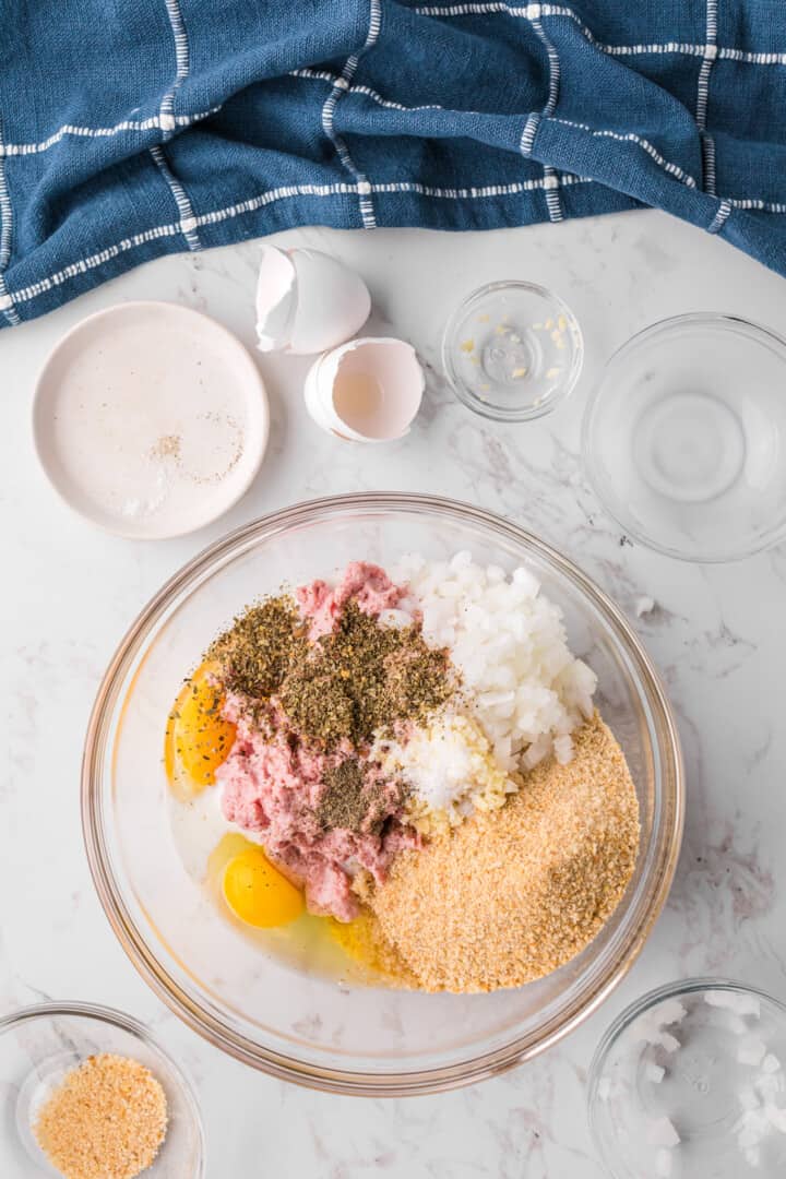 all ingredients for the meatballs in a large glass bowl.