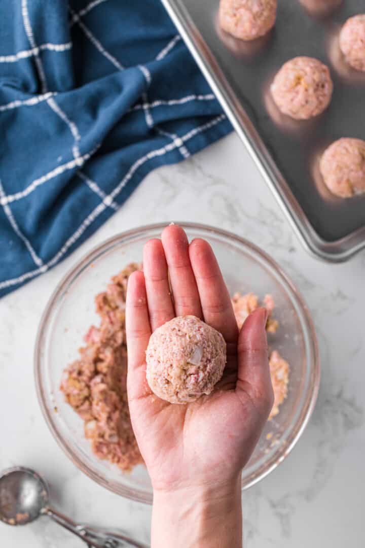 raw turkey meatball rolled into a ball for baking.