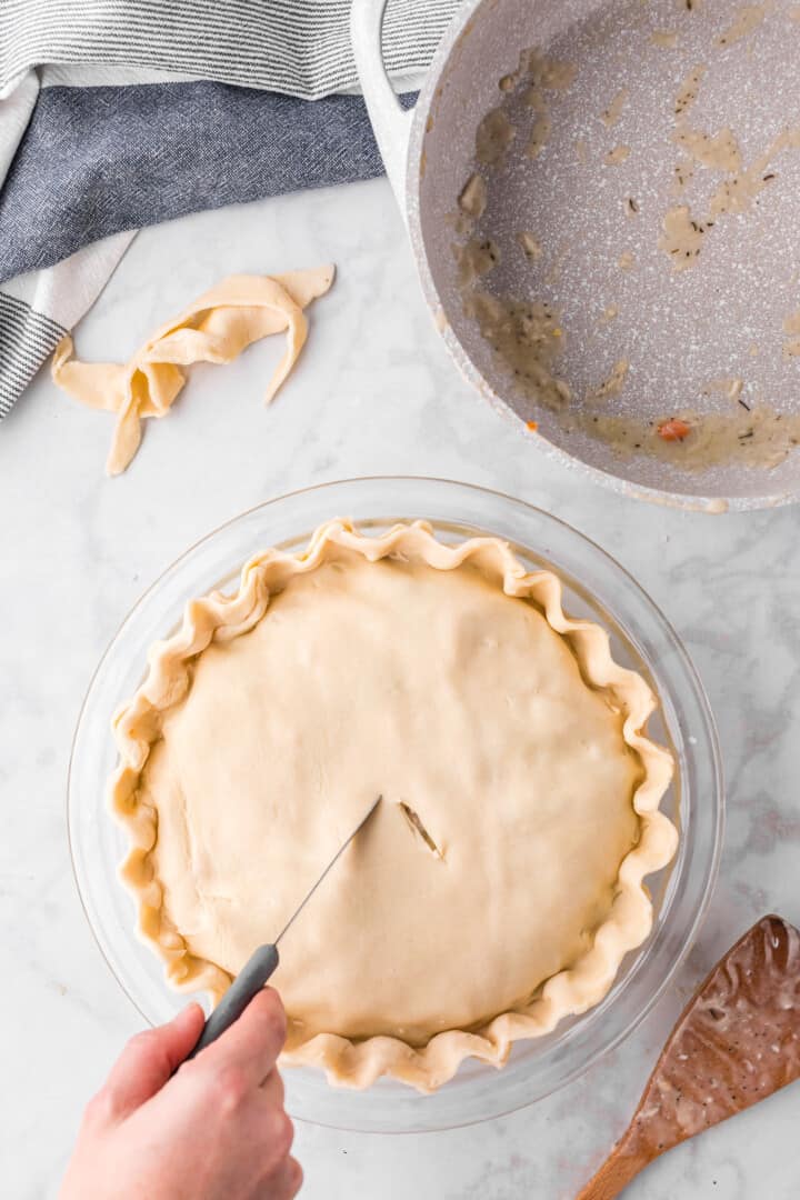 adding the top layer of the pie crust.