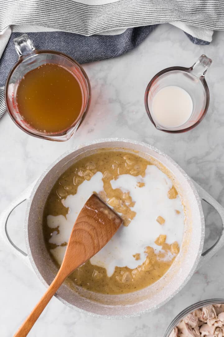 adding in the broth and milk to the filling.