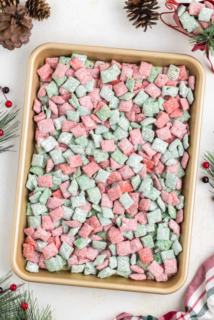 Christmas Muddy Buddies on baking sheet.