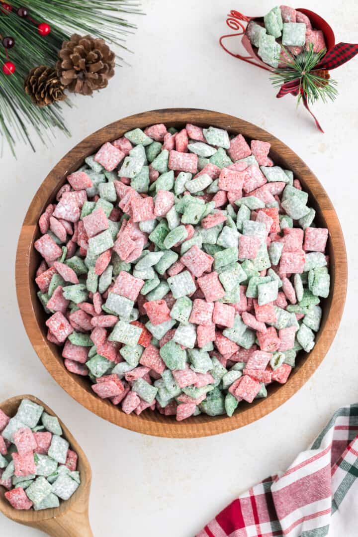 Christmas Muddy Buddies in large wooden serving bowl.